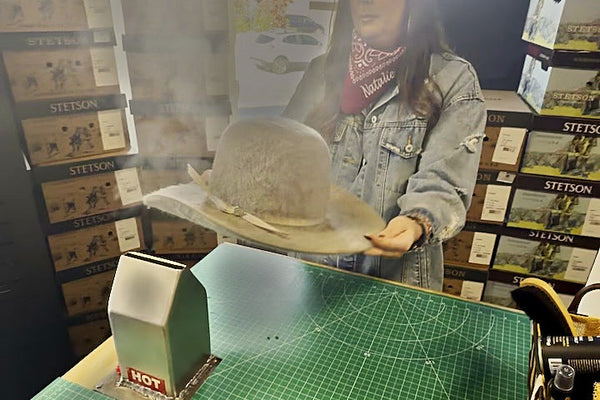 Steaming a felt cowboy hat at the Moon Ridge hat bar