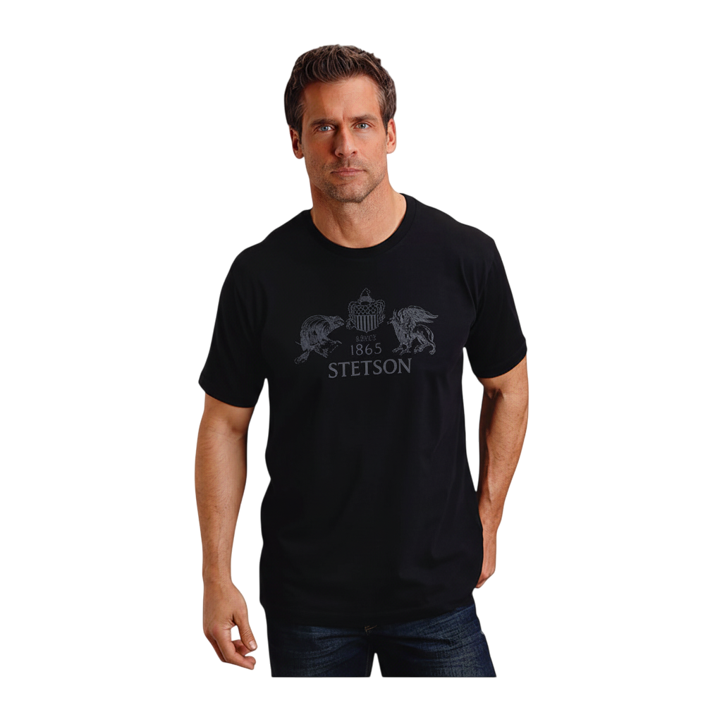 Man wearing a black Moon Ridge Hats and Heritage short-sleeve t-shirt with a Stetson beaver and eagle graphic print.