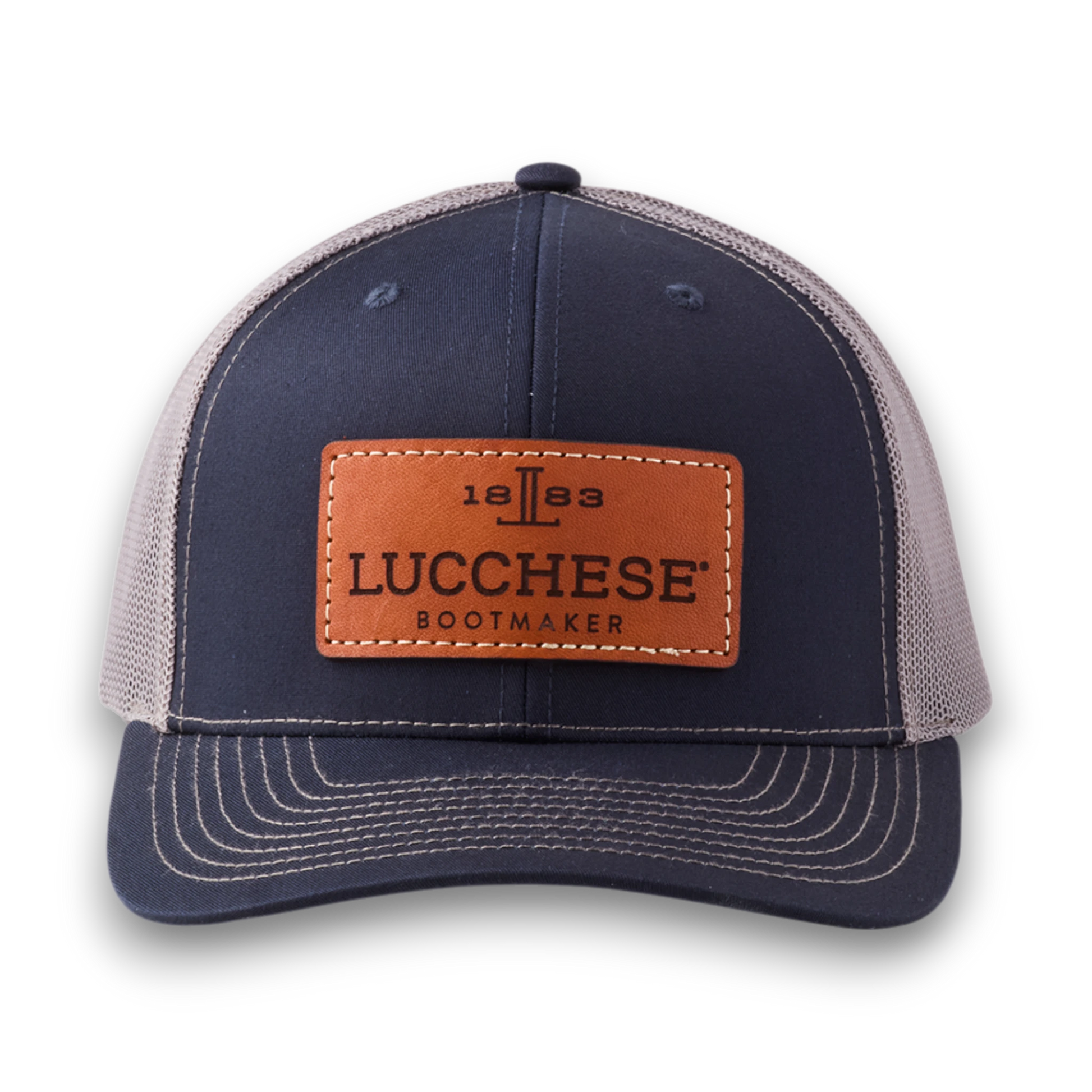 Moon Ridge Hats and Heritage Lucchese navy and charcoal trucker cap with a brown leather logo patch and mesh back