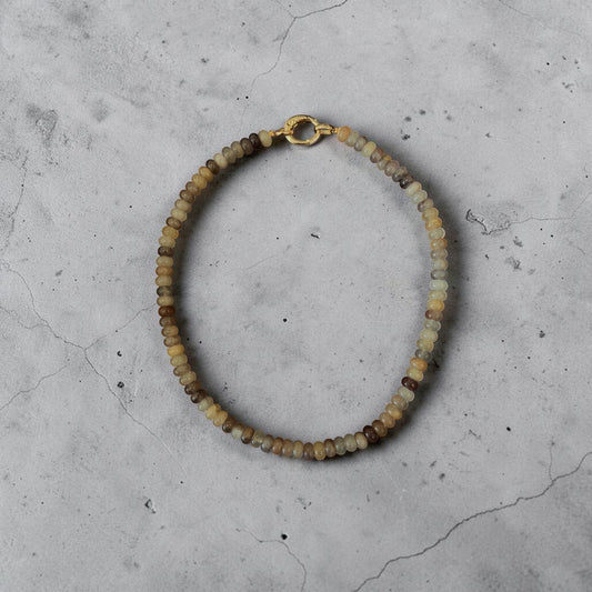 Moon Ridge Hats and Heritage Sahara Beaded Necklace with gold clasp and natural stone beads in earthy tones.