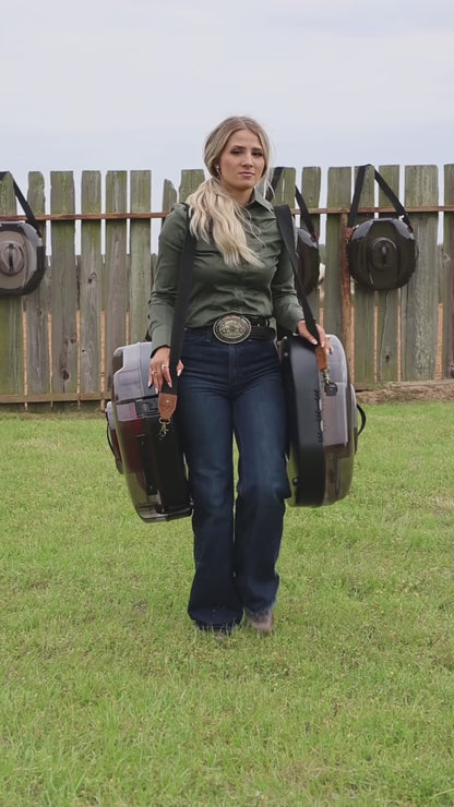 Woman carrying two A Better Hat Can cowboy hat cases by the shoulder strap and top handle