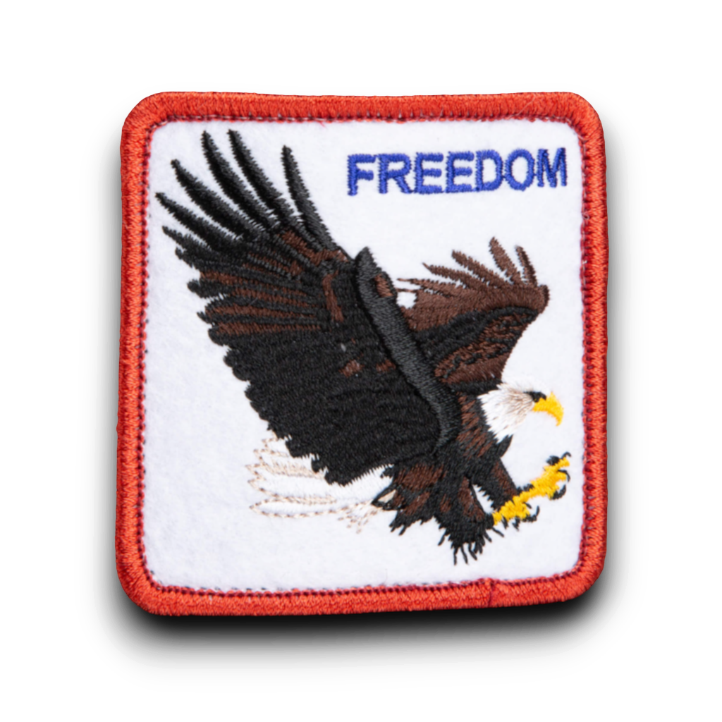 Rafter M Hat Company black trucker hat patch with embroidered eagle and "FREEDOM" text.