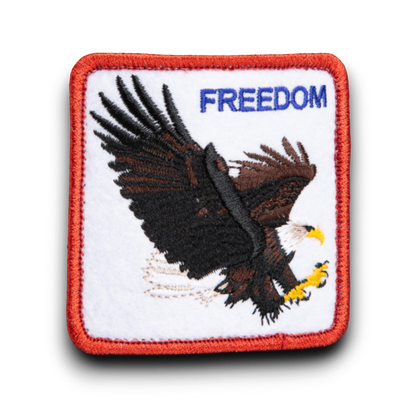 Rafter M Hat Company black trucker hat patch with embroidered eagle and "FREEDOM" text.