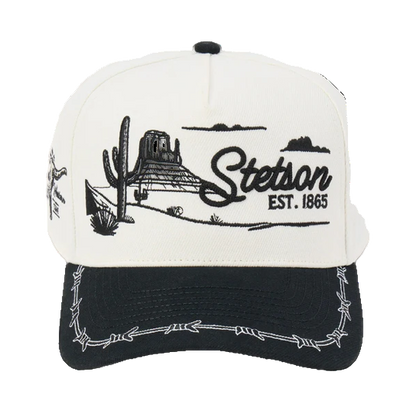 Rafter M Hat Company Stetson trucker hat with embroidered desert landscape, cacti, mesas, and barbed wire brim. White and black.