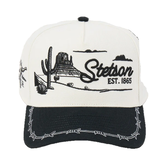 Rafter M Hat Company Stetson trucker hat with embroidered desert landscape, cacti, mesas, and barbed wire brim. White and black.