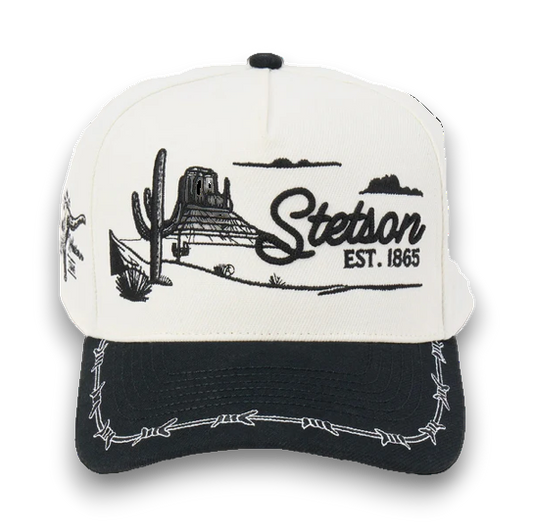 Rafter M Hat Company Stetson trucker hat with embroidered desert landscape, cacti, mesas, and barbed wire brim. White and black.
